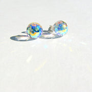 Close-up of Swarovski AB faceted crystal ball stud earrings showing the iridescent Aurora Borealis finish with rainbow light reflections.