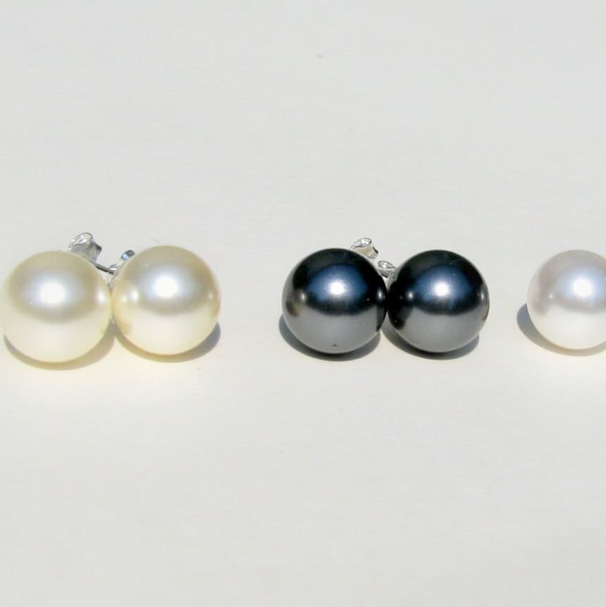 Sophisticated cream pearl stud earrings, a bold but classic alternative to traditional white pearls.