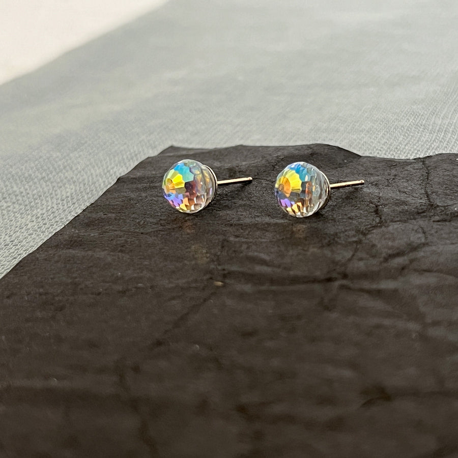 Small 8mm Swarovski AB "mini disco ball" stud earrings close up to show scale and high-shimmer, rainbow sparkle.